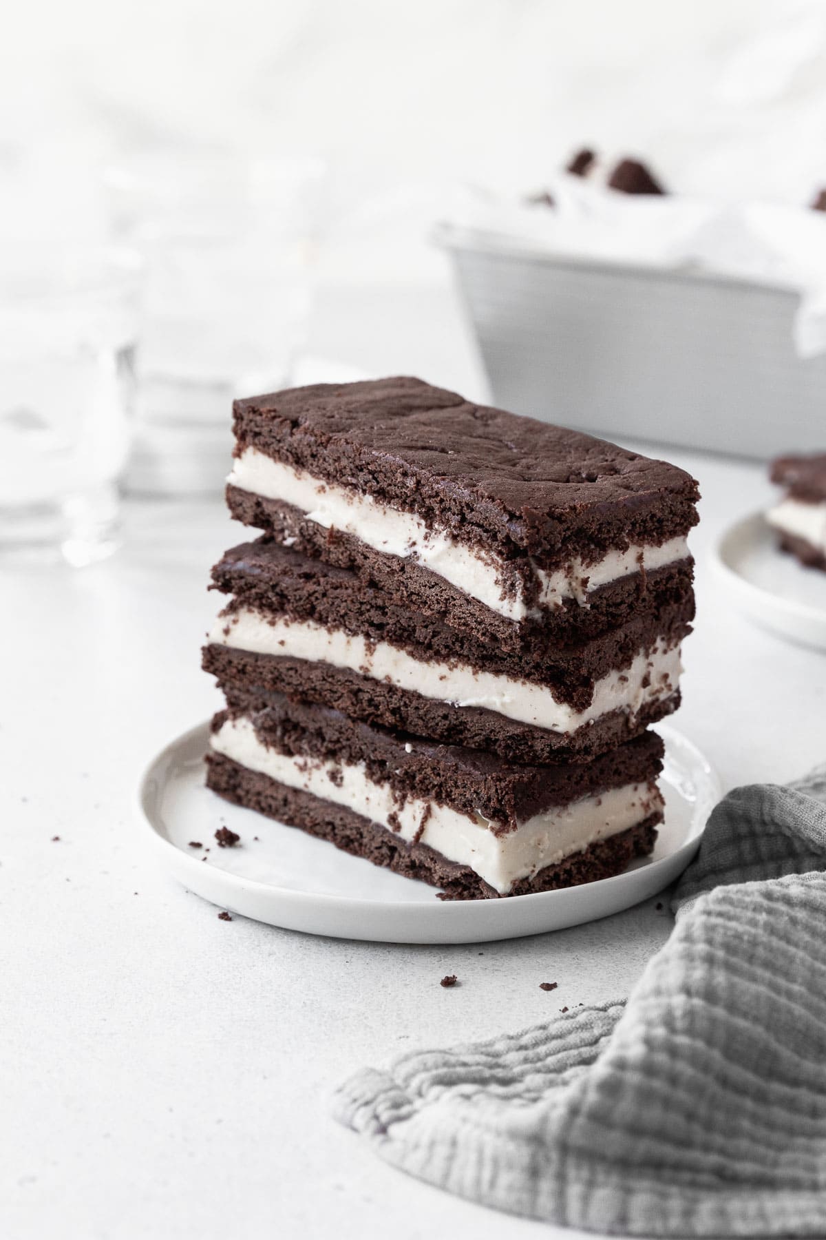 A stack of gluten-free ice cream sandwich cookies on a white dish.
