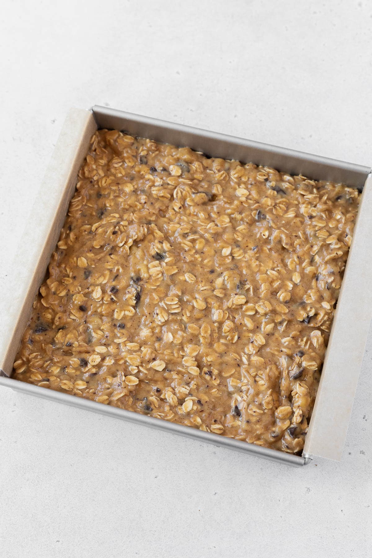 A pan of peanut butter banana oatmeal bars before going into the oven.
