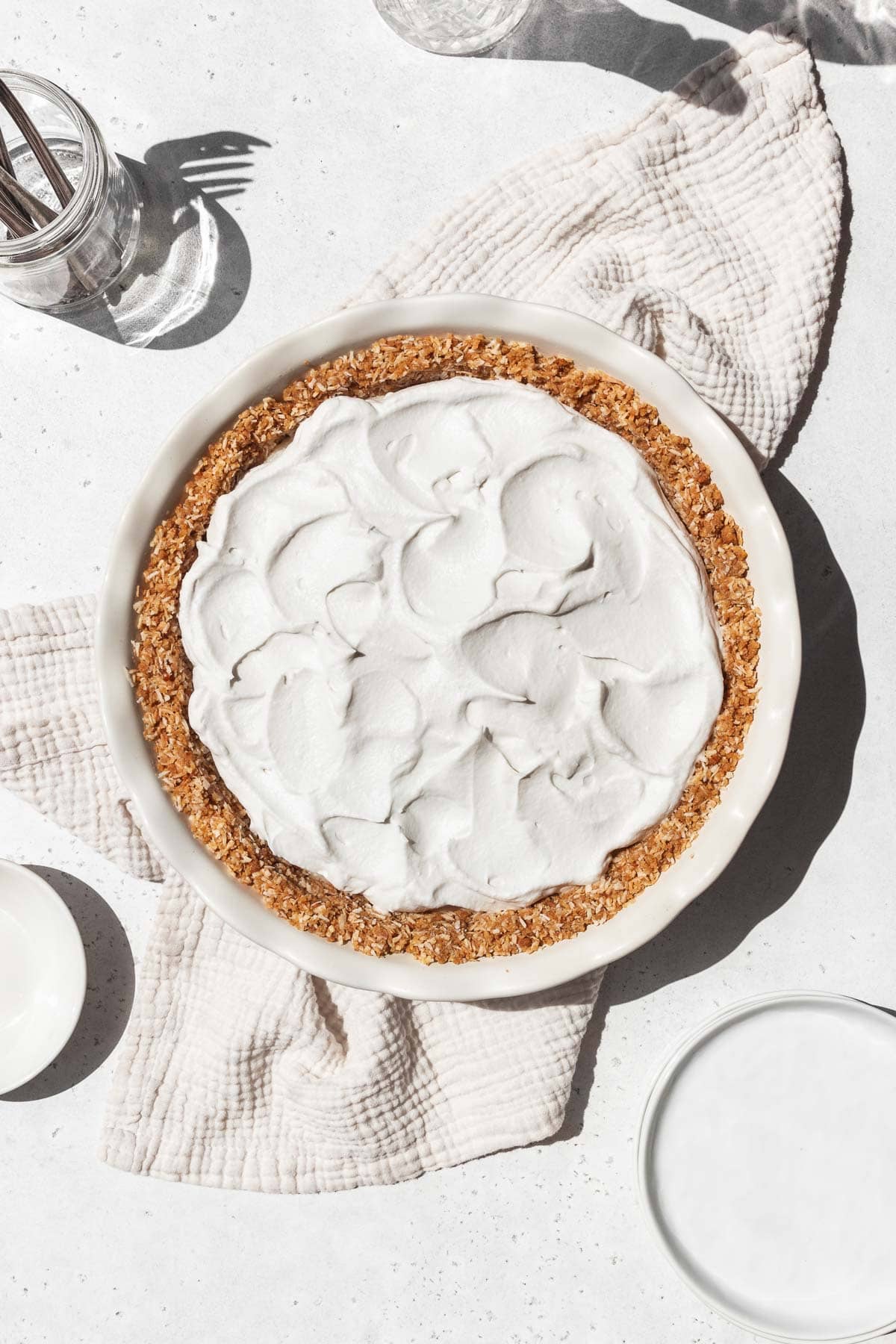 Whipped coconut cream swooshed on top of the vegan coconut custard in the gluten-free pie shell.