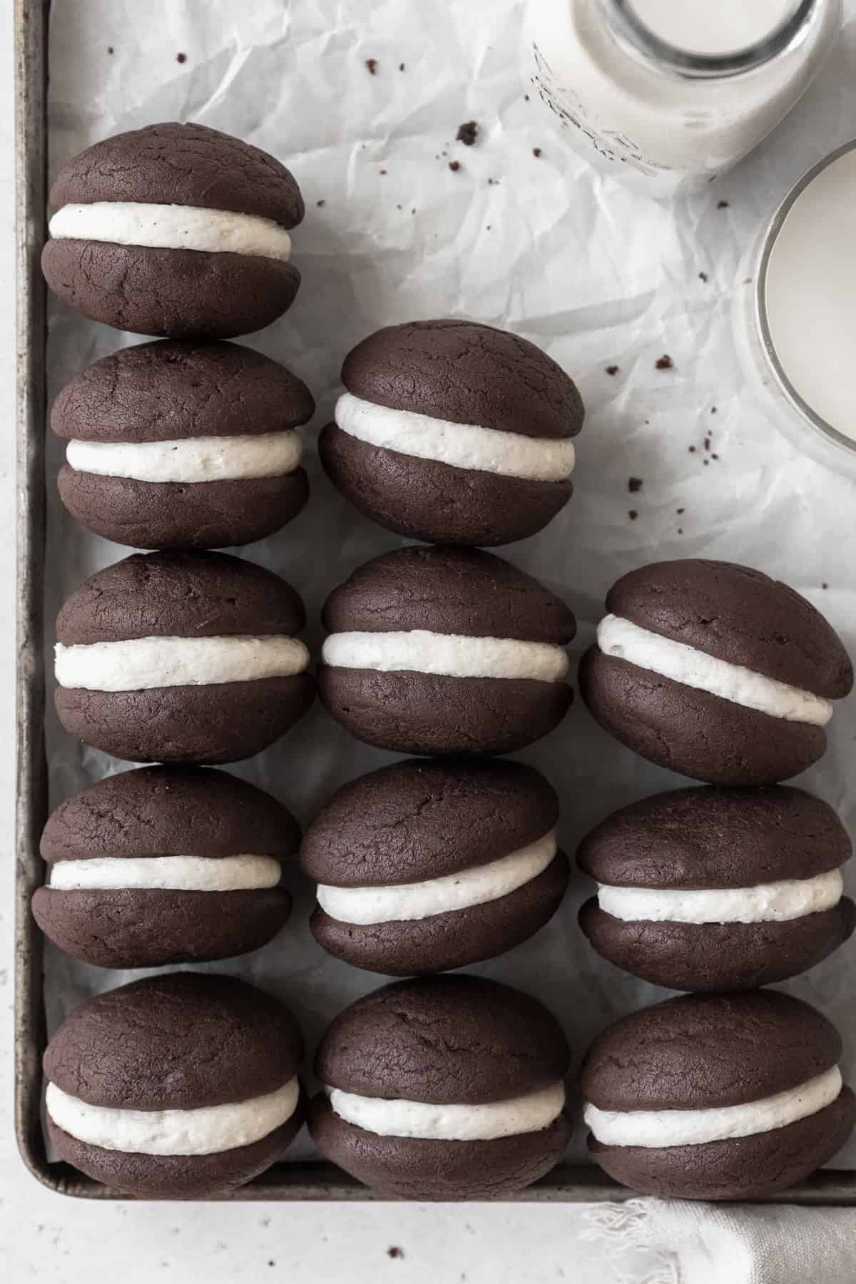 Gluten-free whoopie pies on a parchment-paper lined baking tray.