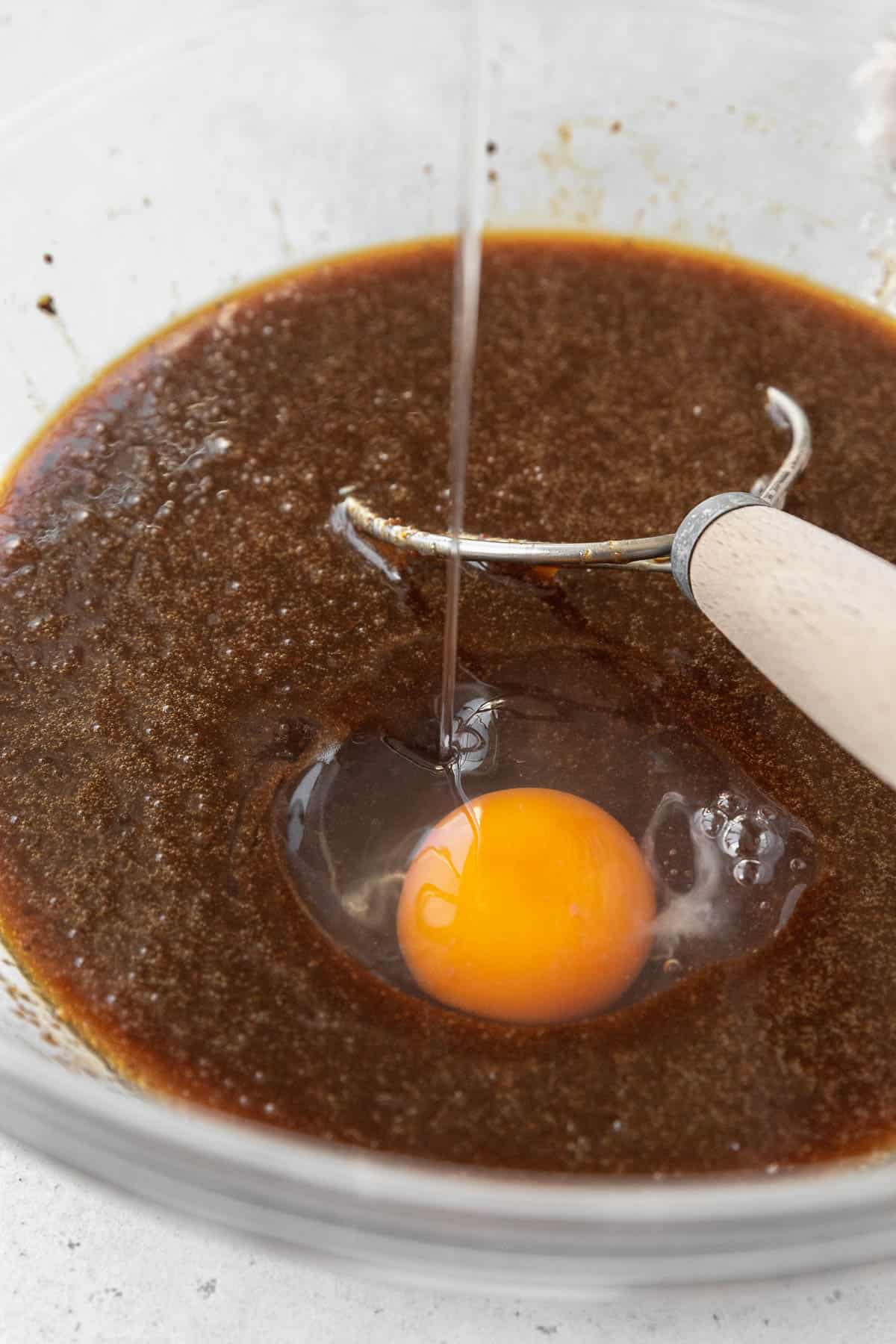 Adding an egg to the gluten-free whoopie pie batter.