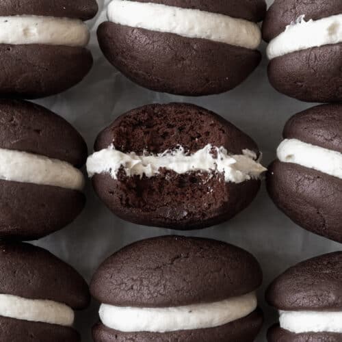 An up-close shot of a gluten-free whoopie pie with a bite taken out of it.