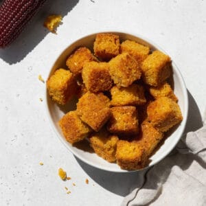 Close-up shot of a small dish of cornbread croutons.