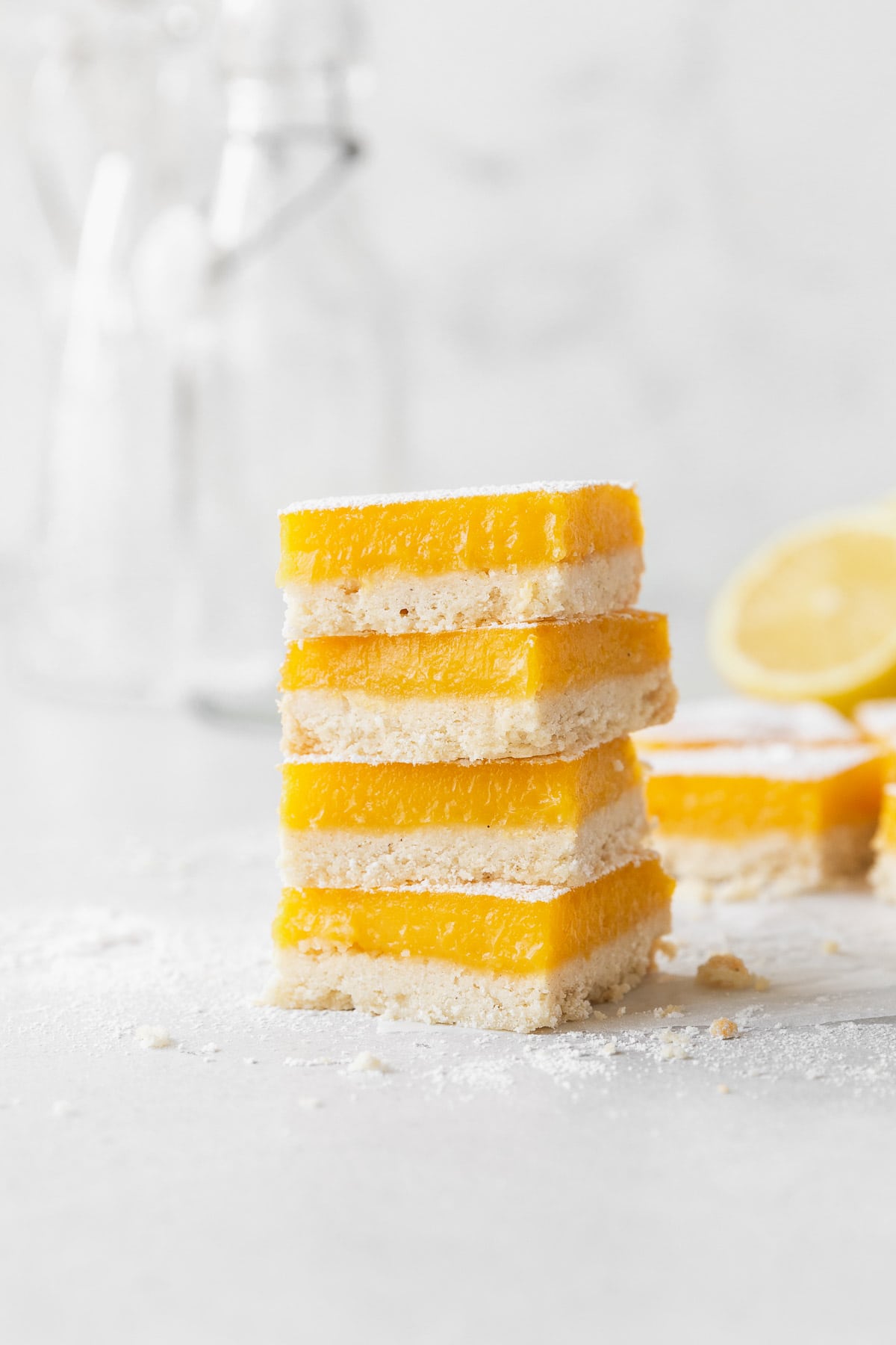A side shot of a stack of dairy free lemon bars on the counter.