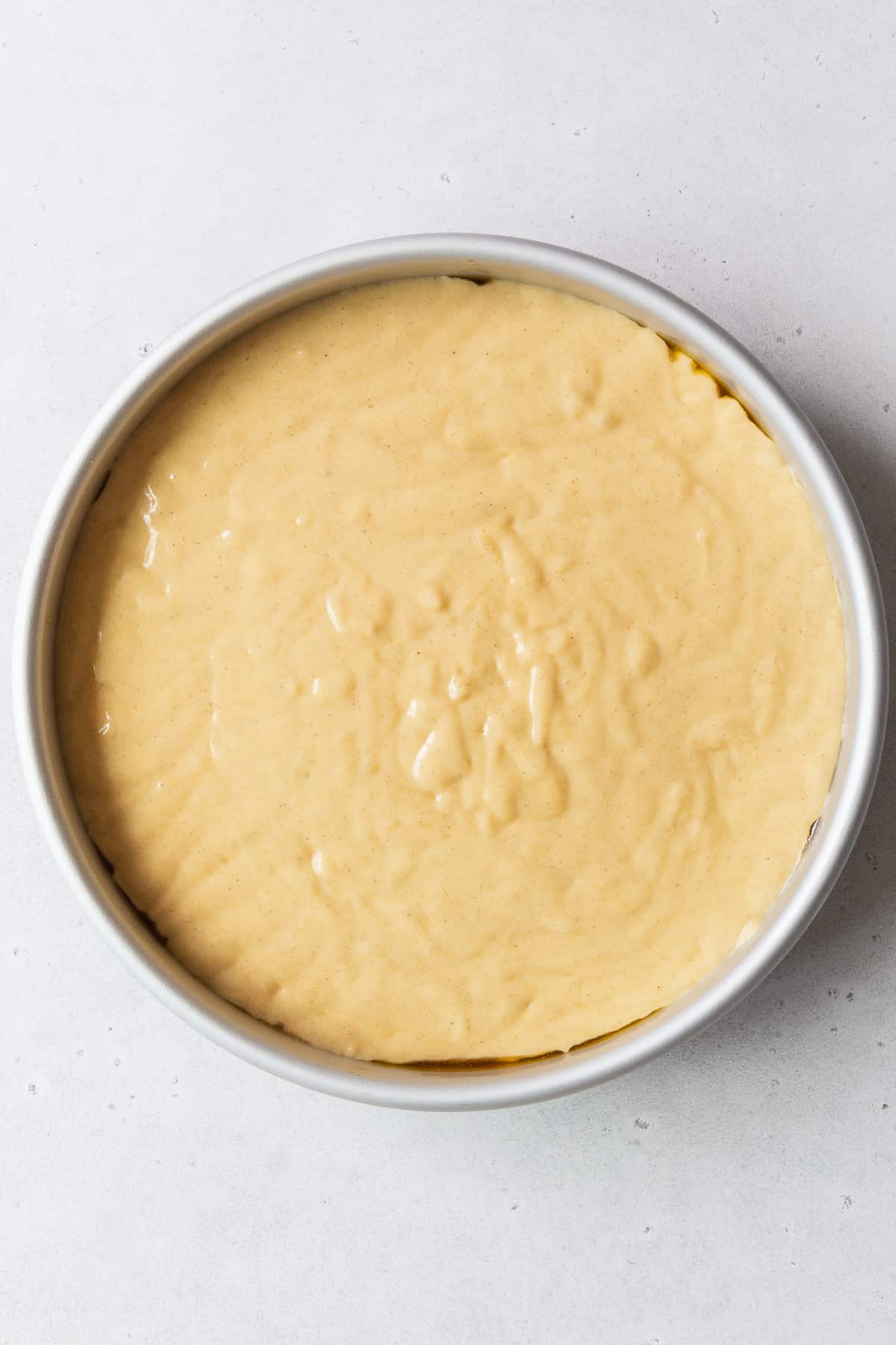 A pan of gluten-free pineapple upside down cake before baking.