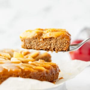 A slice of vegan apple cake being lifted up.